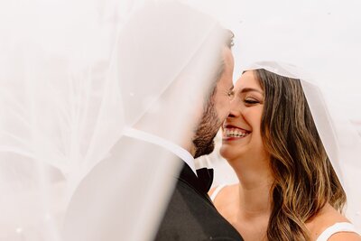 Bride and groom smiling before a kiss