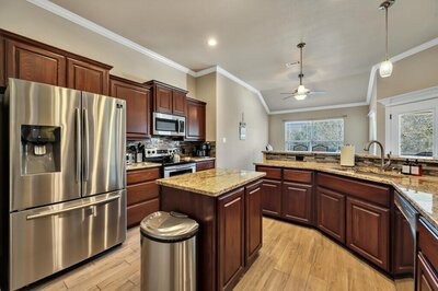 Spacious kitchen with island in this three-bedroom, two-bathroom vacation rental lake house that sleeps eight just steps away from Stillhouse Hollow Lake in Belton, TX.