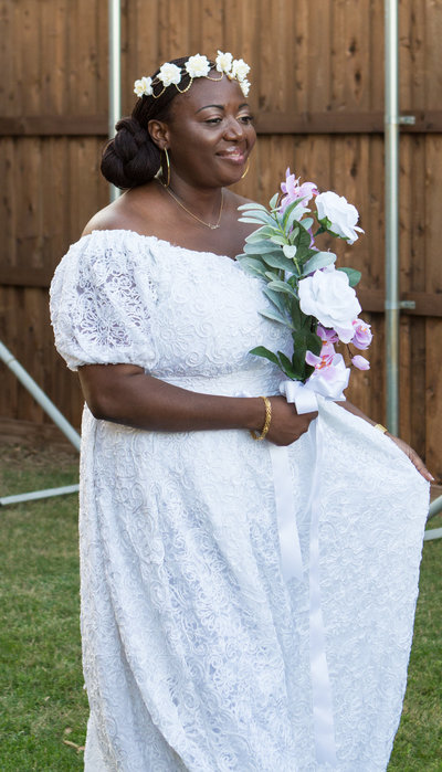 African Bride in White Dress Holding Pink and White Flowers
