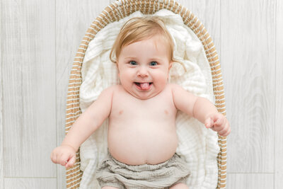 A photo of a baby sticking out its tongue by dc family photographer