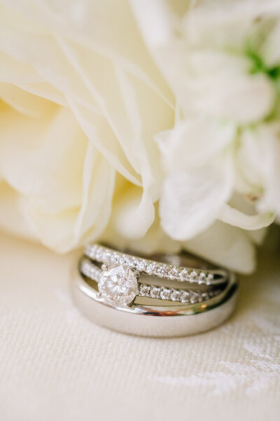 White Flowers and Silver Wedding Bands