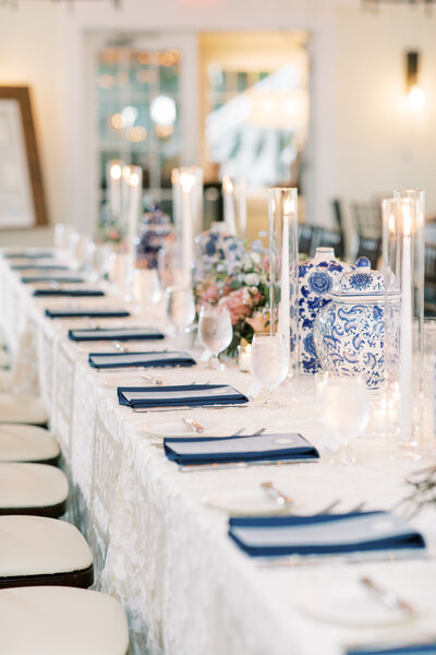 Washington DC Wedding designed by Wedding Planner Blue Sapphire Events. Navy and white tablescape with tall candles and navy napkins.