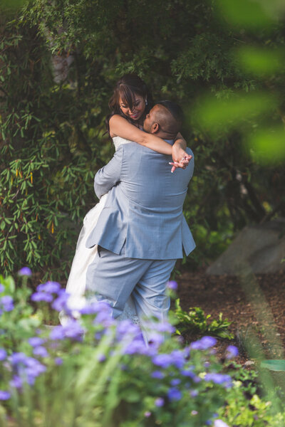 Bride and Groom holding each other in a park