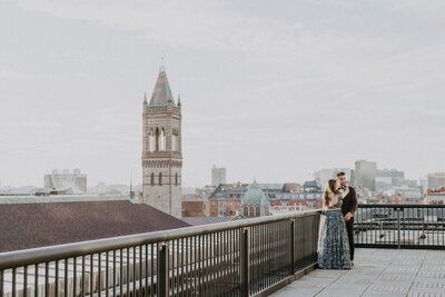 Couple standing together on a rooftop - Unique Melody Events & Design (New England Wedding Planners) were wedding vendors