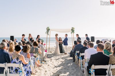 Bride and Groom take their vows on the sands of Crystal Cove Beach in Newport Beach