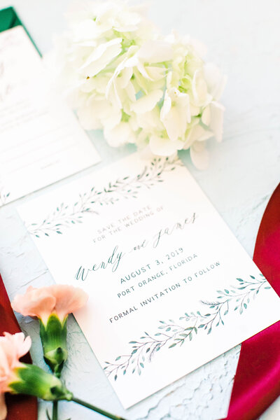 hand painted save the dates with watercolor leaves and greenery