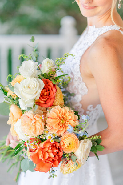 Close up of a bride's colorful bouquet on the porch of Flying Horse Ranch in Larkspur.