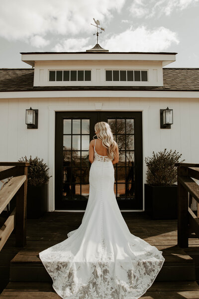 bride posing in front of cottage