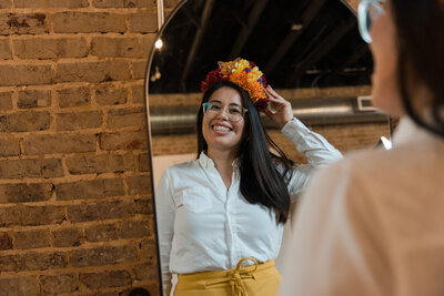 A vibrant woman adorned in a handmade yellow flower crown. Explore the spirit of happiness, creativity, and self-expression at Soleil Vida Studio. Embrace the journey of inner GLOW-up and celebrate the beauty of individuality with our empowering workshops and community of like-minded mujeres.