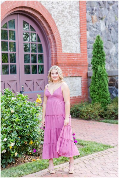 high school senior in pink dress standing at the conservatory at Biltmore
