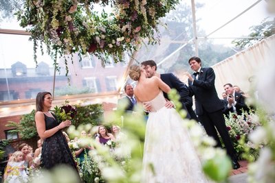 Bride & groom with creative floating flower arrangement