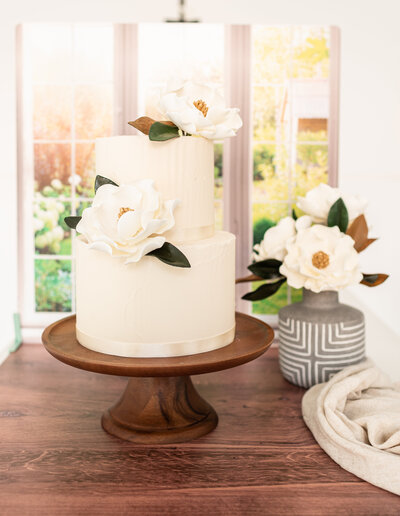 Close up of a Modern magnolia Sugar flowers On a two tier cake