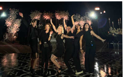 Florida wedding planning team wearing black outfits standing  outside at night