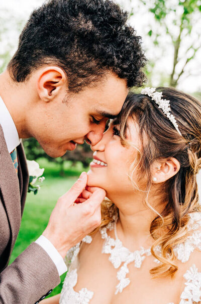 A mixed couple kisses for their wedding photographer at a country club in Cincinnati, Ohio