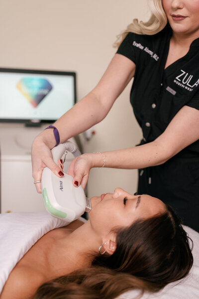 Woman laying down receiving a medspa treatment on her face