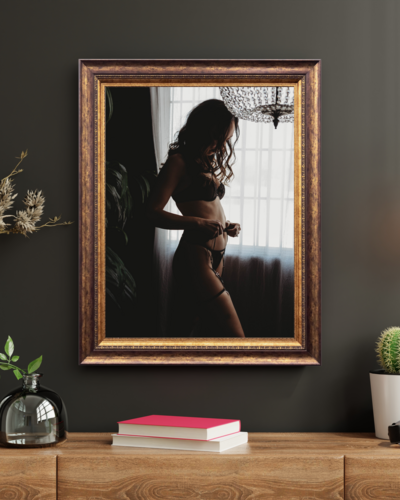 wall art display of boudoir image of woman in lingerie under a chandelier with curls