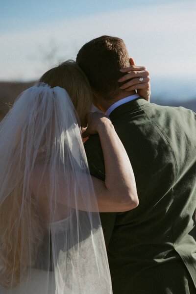 An intimate moment between a young couple celebrating their elopement in the greenville sc mountains.