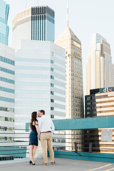 Couple kissing with the Minneapolis skyline