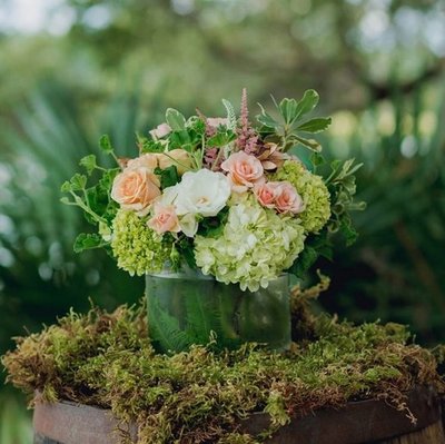 Flowers are set on moss at ceremony site at I'on Creek Club. Kate captures Charleston wedding photos.