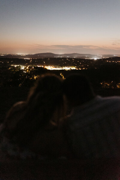couple looking at night lights from cliffside in Northern Alabama