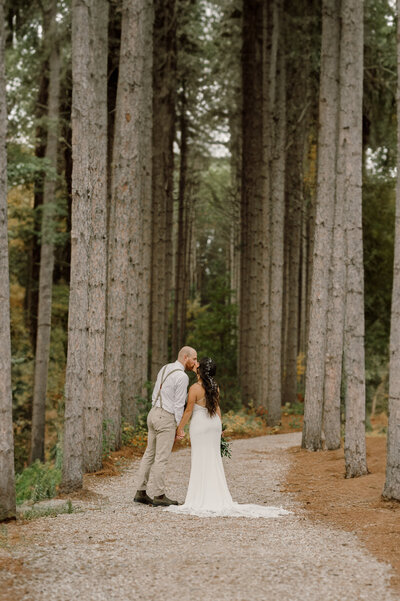 The groom and bride shared the kisses middle of forest
