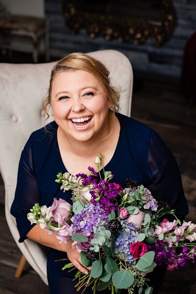 Headshot photo for Murfreesboro florist showcasing a colorful purple and pink bouquet with heavy greenery