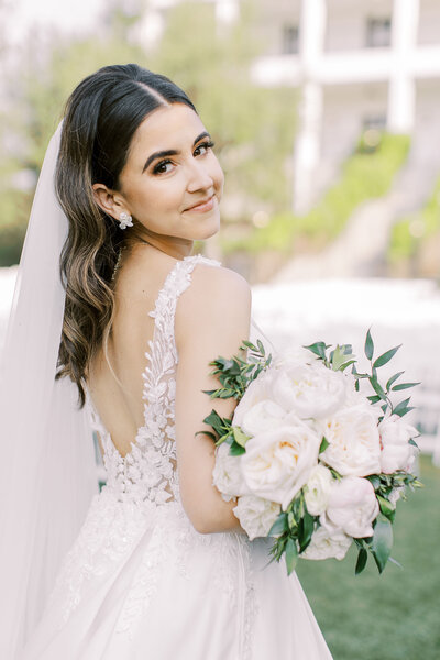 bride holding lush white bouquet