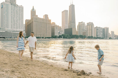 Family of four walking along Ohio St Beach in downtown Chicago by Chicago photographer Kristen Hazelton