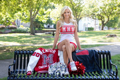 Sports senior pictures of a high school senior cheerleader in a park by Northeast Ohio Photographer, Sharon Holy