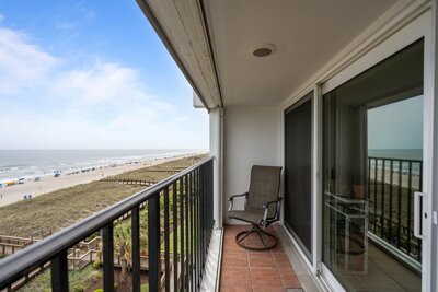 Oceanfront balcony with seating at 222 Carolina Beach, offering views of the shoreline and beach