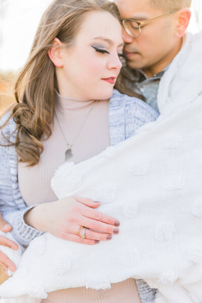 luxury couples portrait with guy in grey sweater and girl in tan shirt wrapped in a soft blanket in ohio