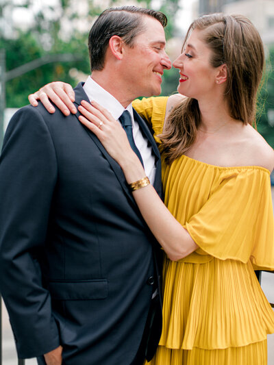 man and woman smiling in yellow dress