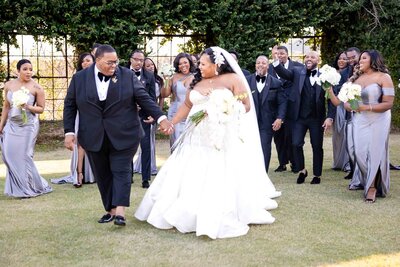 Bride and groom having a candid moment with their bridal party 