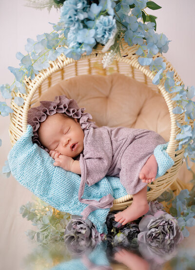 baby girl wearing lilac outfit sleeping