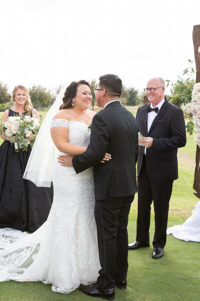 An Austin-based wedding photographer captures a heartfelt kiss between a bride and groom during their wedding ceremony.