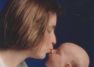 Woman kissing her child on the nose