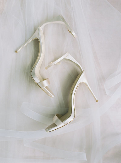 Boston Bride's golden shoes over veil detail shot