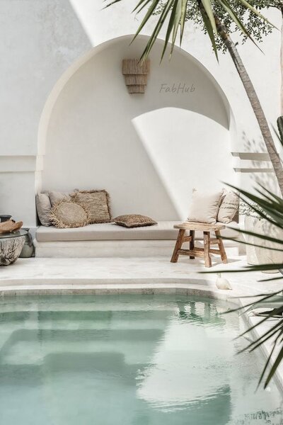 Lush Mediterranean backyard with whitewashed walls and tropical greenery.