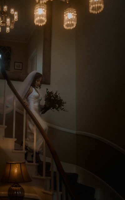 ride walking down the stairs, captured in a graceful moment that blends elegance with anticipation, as she steps toward her new beginning with poise and beauty