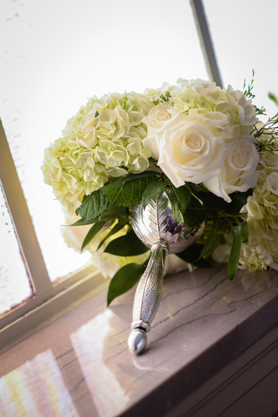 white bridal bouquet with silver tussy mussy holder at a Mississippi Delta Wedding