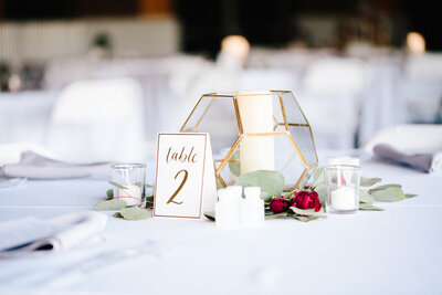modern glass and gold geometric wedding centerpiece with candle at jackson hole wedding