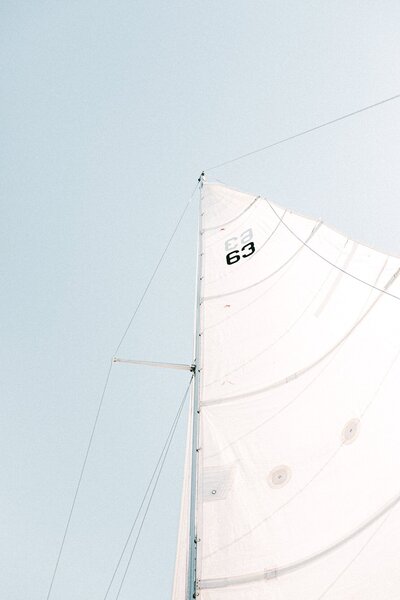 a white sail against the blue sky