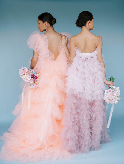 women wearing pink and purple dress holding bouquets during bridal portraits