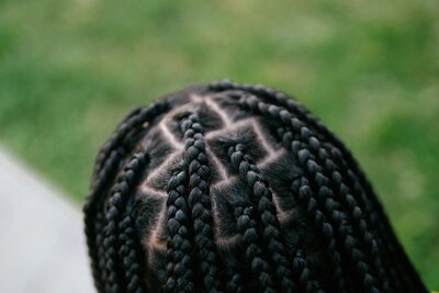 Box braids on a Black woman turned away from the camera