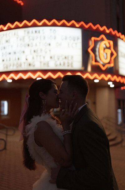 bride and groom kissing downtown