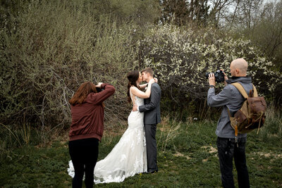 Des Moines Iowa wedding couple where the guy lifted his fiance up and they kiss.