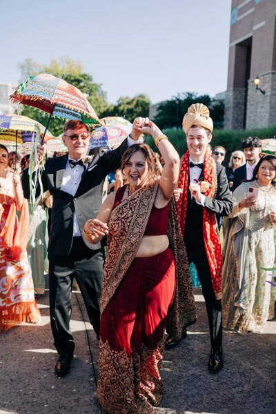 A joyful dance at a multicultural wedding celebration.