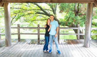 Husband & wife with arms around each other at the Japanese Gardens Ft. Worth
