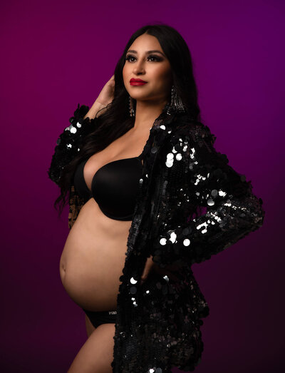 Pregnant mom wearing a shiny jacket