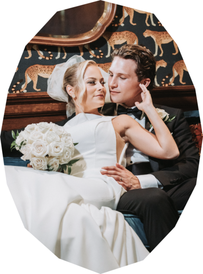 Bride with full white rose bouquet relaxed against groom - professional photo edit by Uncut Gems